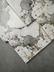 Collection of PVC marble sheets and UV panels in various artistic textures, including Golden Vein and Statuario, for luxury interior wall decor.