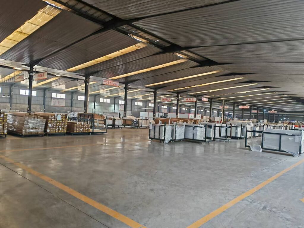 Spacious factory warehouse showcasing massive inventory of finished WPC wall panels and UV sheets ready for international wholesale shipping.